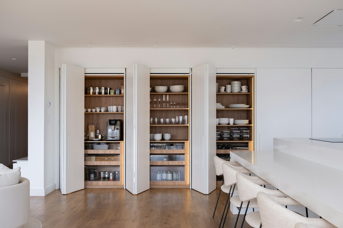 Built-in pantry shelves with dry goods stored in jars and closed containers